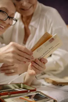 Elderly women with eyeglasses enjoying cherished old photographs together.